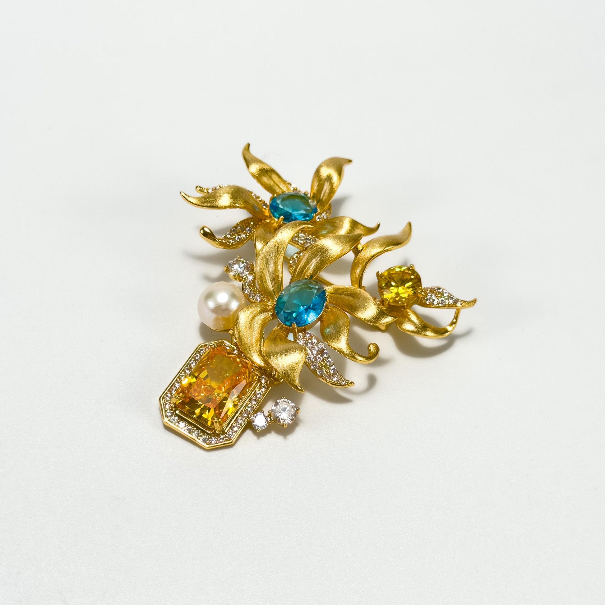 This Gold Vase Brooch Features a Bouquet of Lilies
