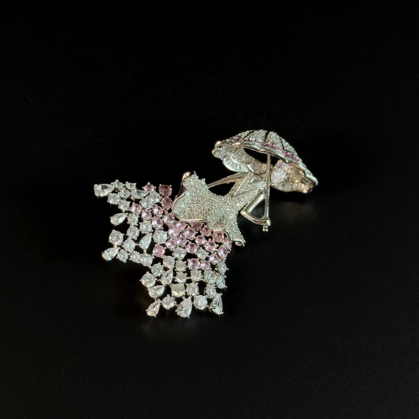Brooch Featuring a Person Holding an Umbrella