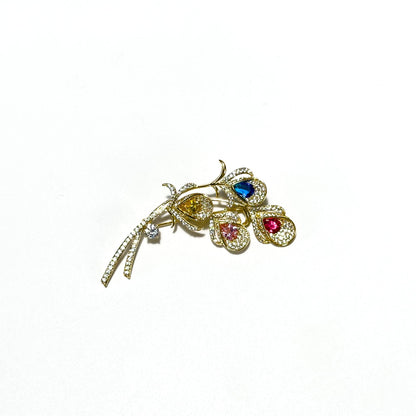 Alope · Golden Peacock Feather Brooch