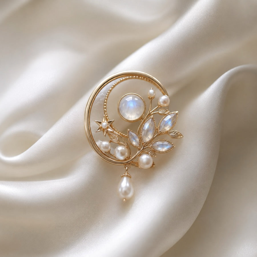 Pearl and moonstone brooches on silk